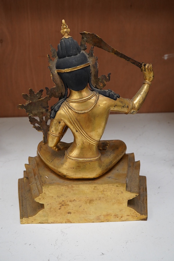 A gilt bronze figure of Manjushri, 31cm